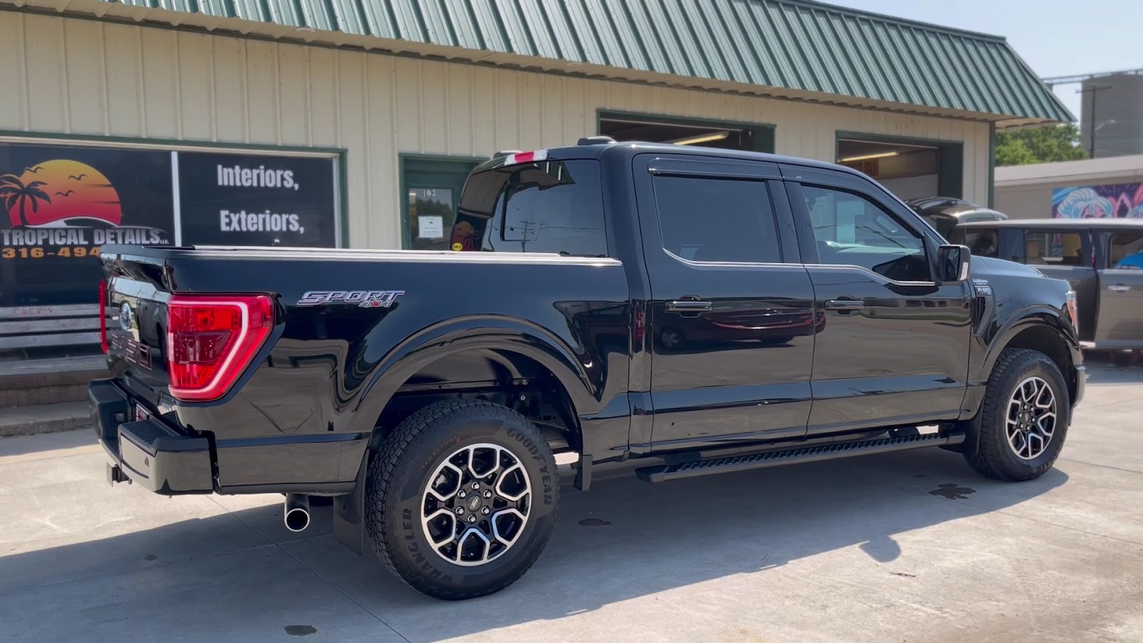 Black Ford F-150 Sport detailed outside the shop