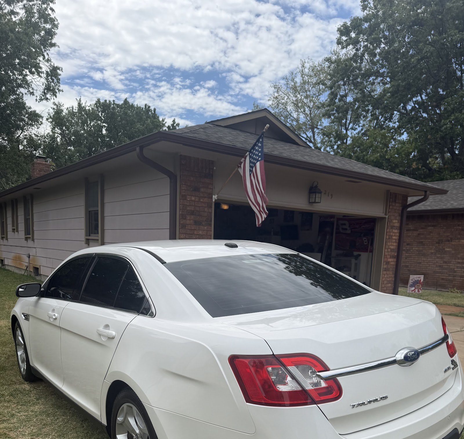 White Ford Taurus with tinted windows